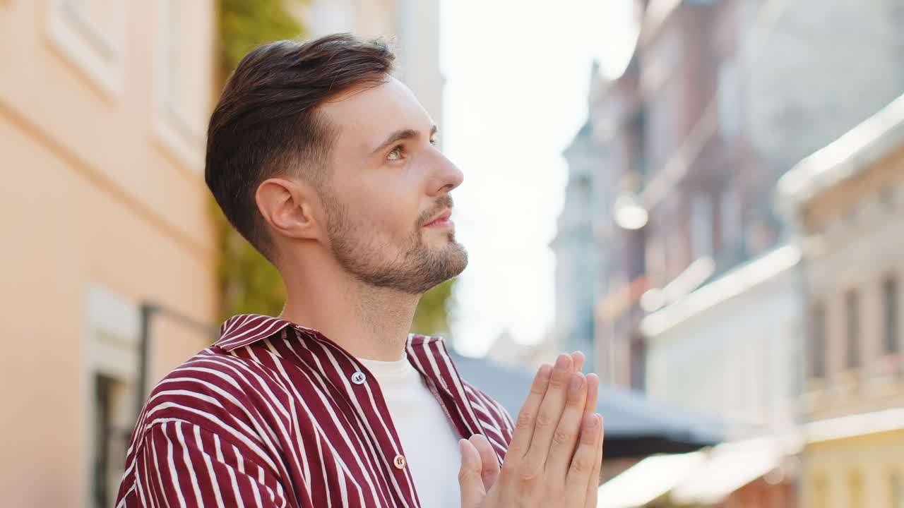 Portrait of bearded man praying closed eyes to god asking for blessing help forgiveness outdoors