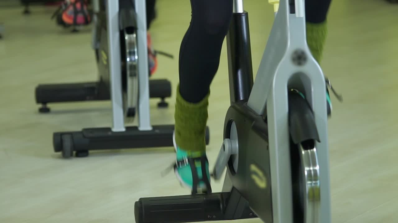 People on Spin Bikes in a Gym