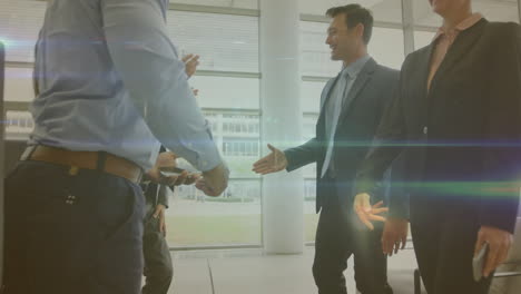 animation of network of profiles and light trails over diverse bsinesspeople shaking hands at office