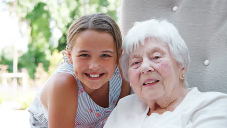 portrait of granddaughter visiting grandmother in retirement home