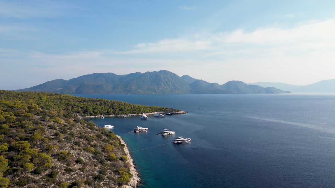 Aerial View of Yachts Moored in a Calm Bay with Mountains in the Background