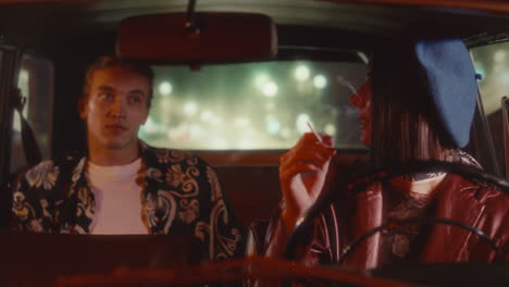 young retro-dressed woman driving car, smoking and chatting with boyfriend