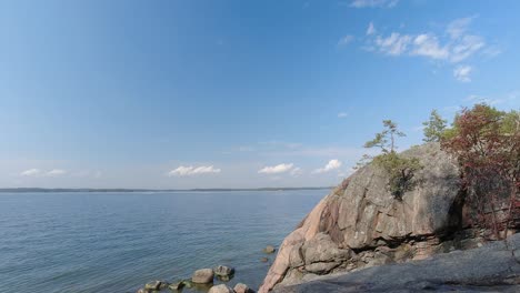 time lapse of a lake with large rocks on the shore