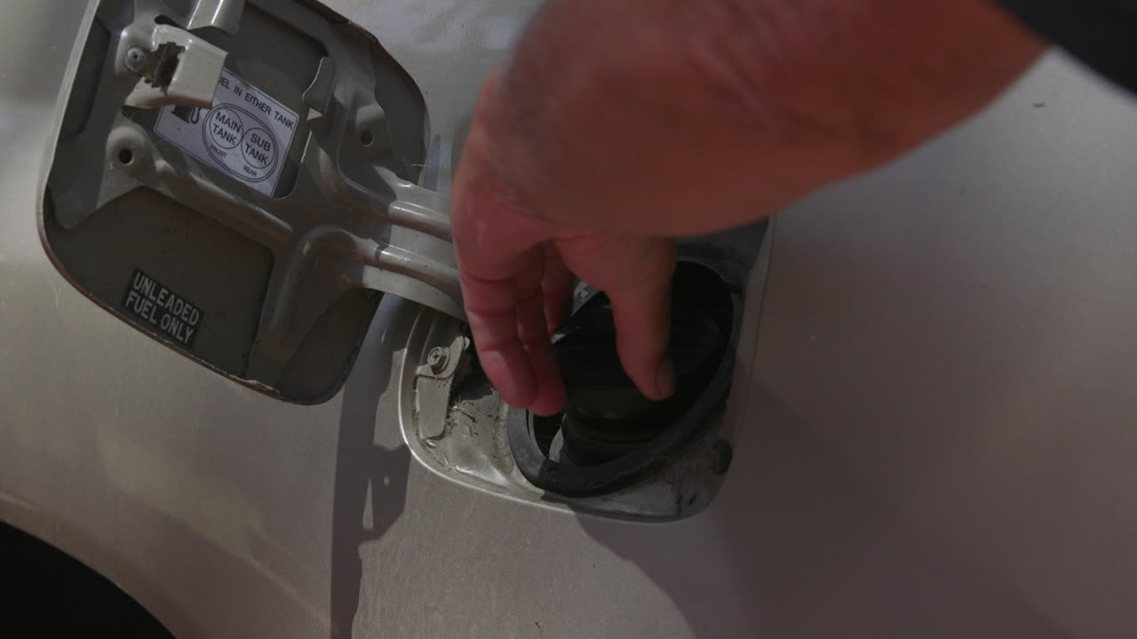 Opening the fuel cap on a motor vehicle