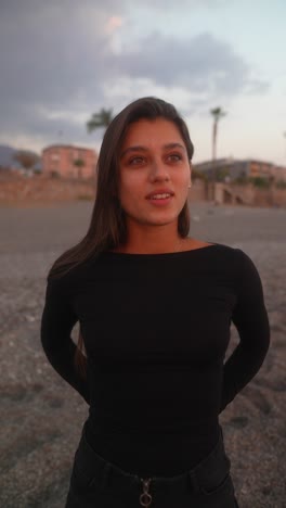 young woman at the beach sunset