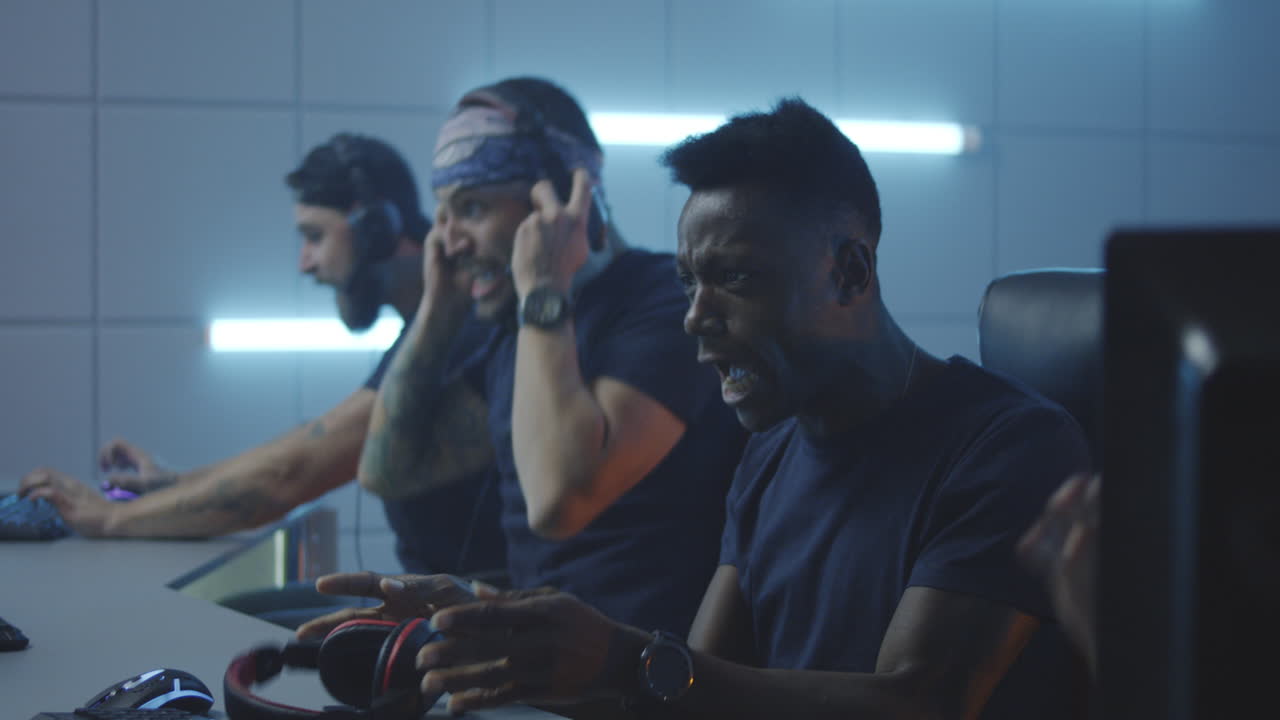 Of Multicultural Female Cybersport Team Winning Game and Cheering Medium Shot of Young Muslim Female Gamer and Asian Teammate Playing in Online Video Game with Tense and Focused Look Winning Match Cheering and Pumping Fists while Celebrating Victory