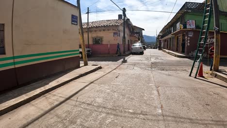 exploring a vibrant colonial street filled with life in a mexican town