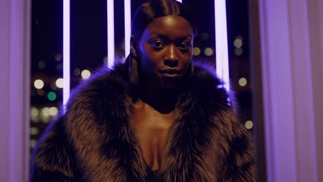 elegant woman in a fur coat under neon lights