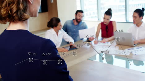 business team discussing data trends with graph animation overlay in conference room