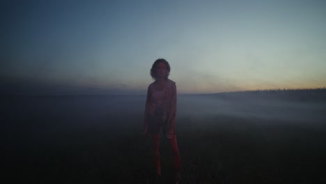 woman in a field at dusk