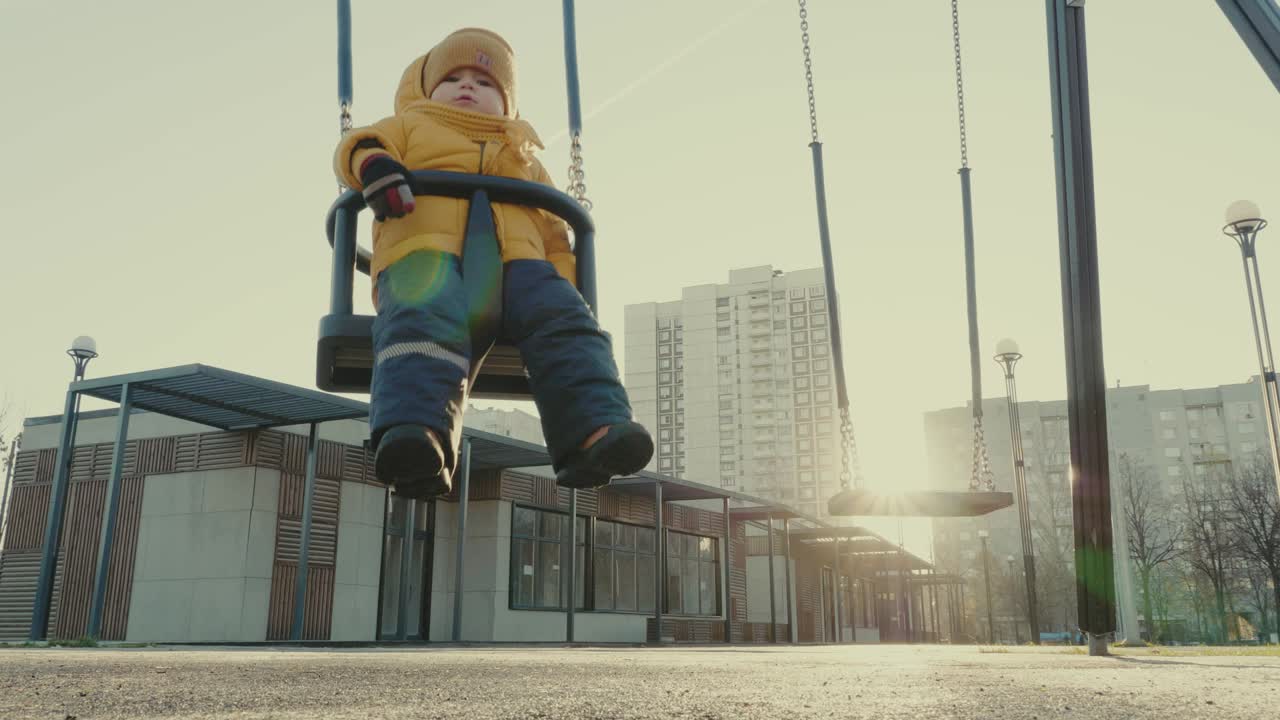Child on a swing in an urban park