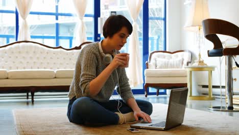 woman using mobile phone in living room