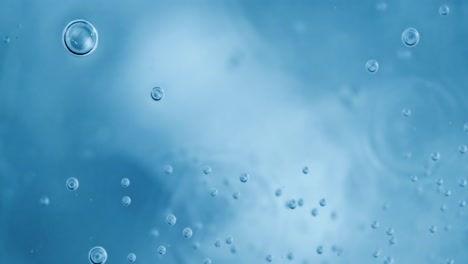 Oxygen-bubbles-in-water-on-a-blue-abstract-background-on-super-slow-motion.