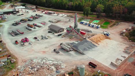 Close-up-view-of-a-ready-mix-concrete-supplier-site-in-Dawsonville,-Georgia---loaded-trucks-and-heavy-construction-machinery-parking-on-site