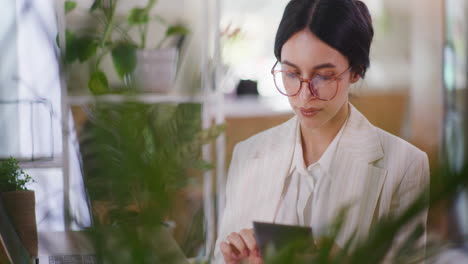 Woman-Using-Calculator-While-Working