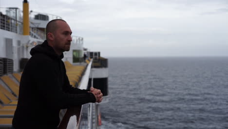 Man-stands-on-deck-of-cruise-ship