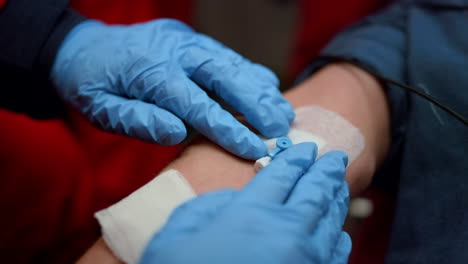 unrecognizable doctor providing first aid help to patient