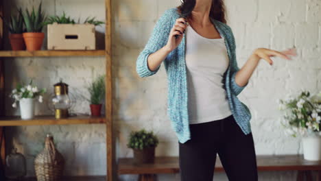 woman singing and dancing at home