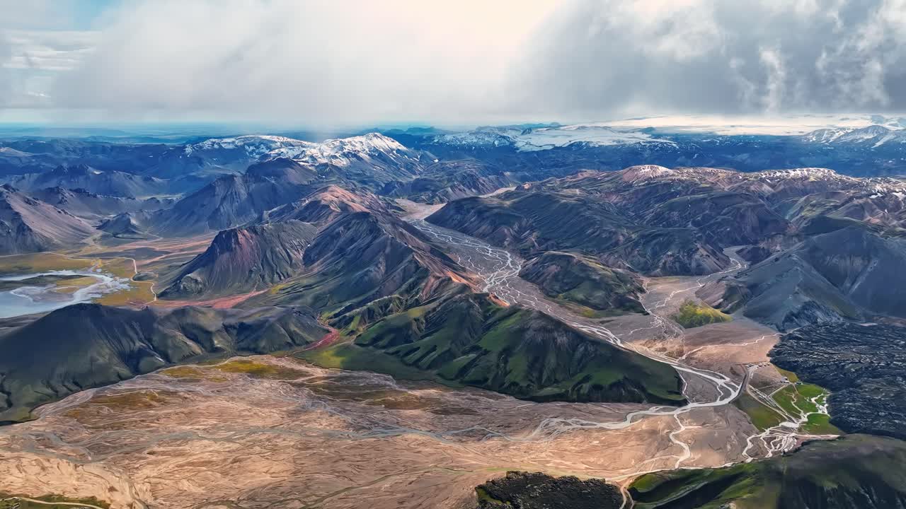 Scenic rhyolite mountains and alley drone view at cloud level. Iceland highlands