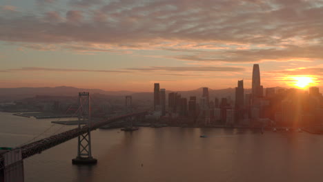 aerial slider shot of san francisco skyline and bay bridge at sunset