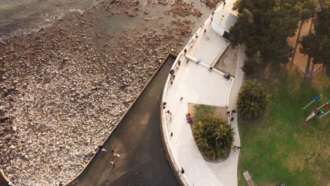 Aerial-top-down-show-showing-rocky-beach-with-river-at-Torre-Belem-Building-at-sunny-day