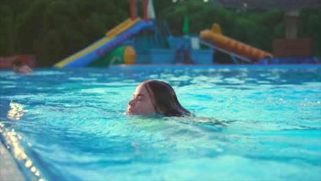 woman enjoying the summer day at swimming pool