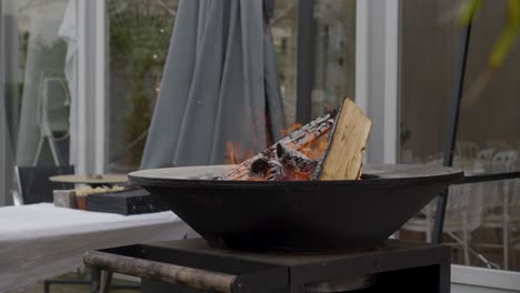 Outdoor-fire-pit-with-red-flame-at-wedding-reception