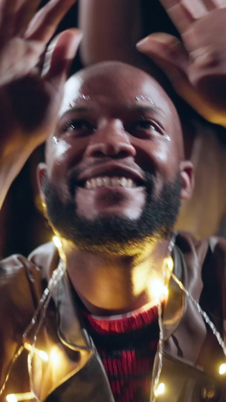 Happy Man Dancing at Night Party with Fairy Lights