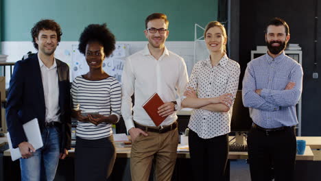 young multiethnic business team looking at camera in the office