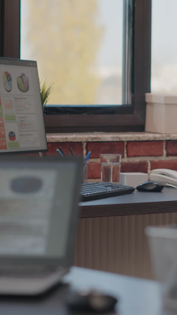 Office Desk with Computer and Data Analysis Display
