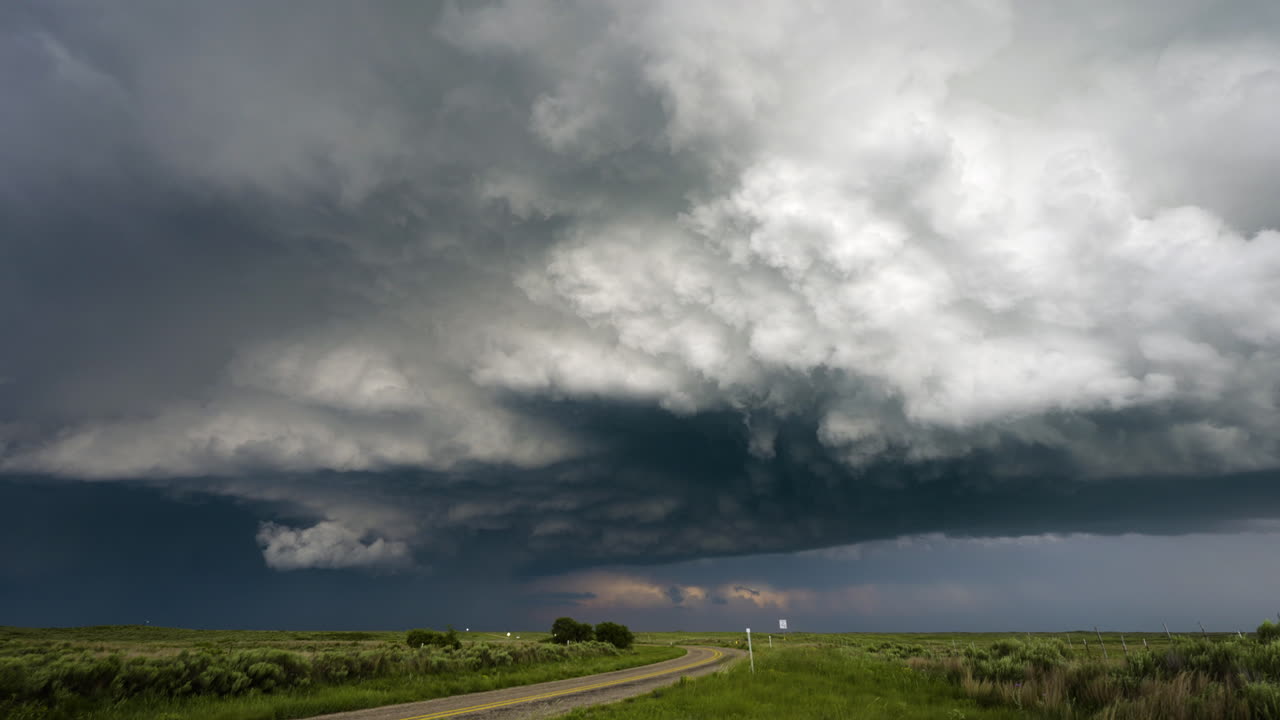 Winding Country Road Under Amazing Stormy Textured Sky With Wind Blowing
