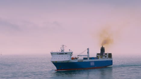 cargo ship vessel sailing on calm sea in english channel transporting goods to grow global economy with diesel fumes coming out funnel 4k