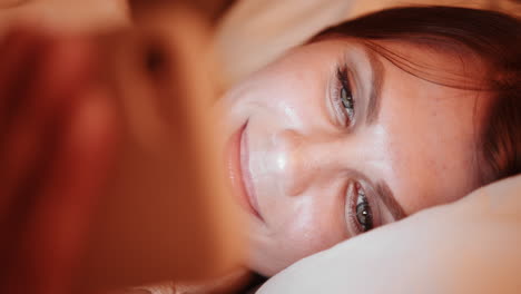 woman using a smartphone in bed at night