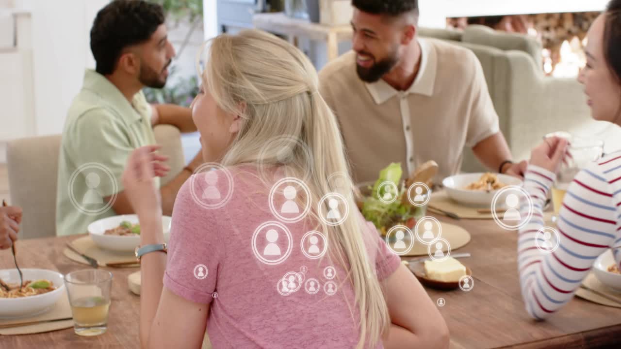 Blonde woman turning to camera joining social chat after men gesturing, icons clustering over table