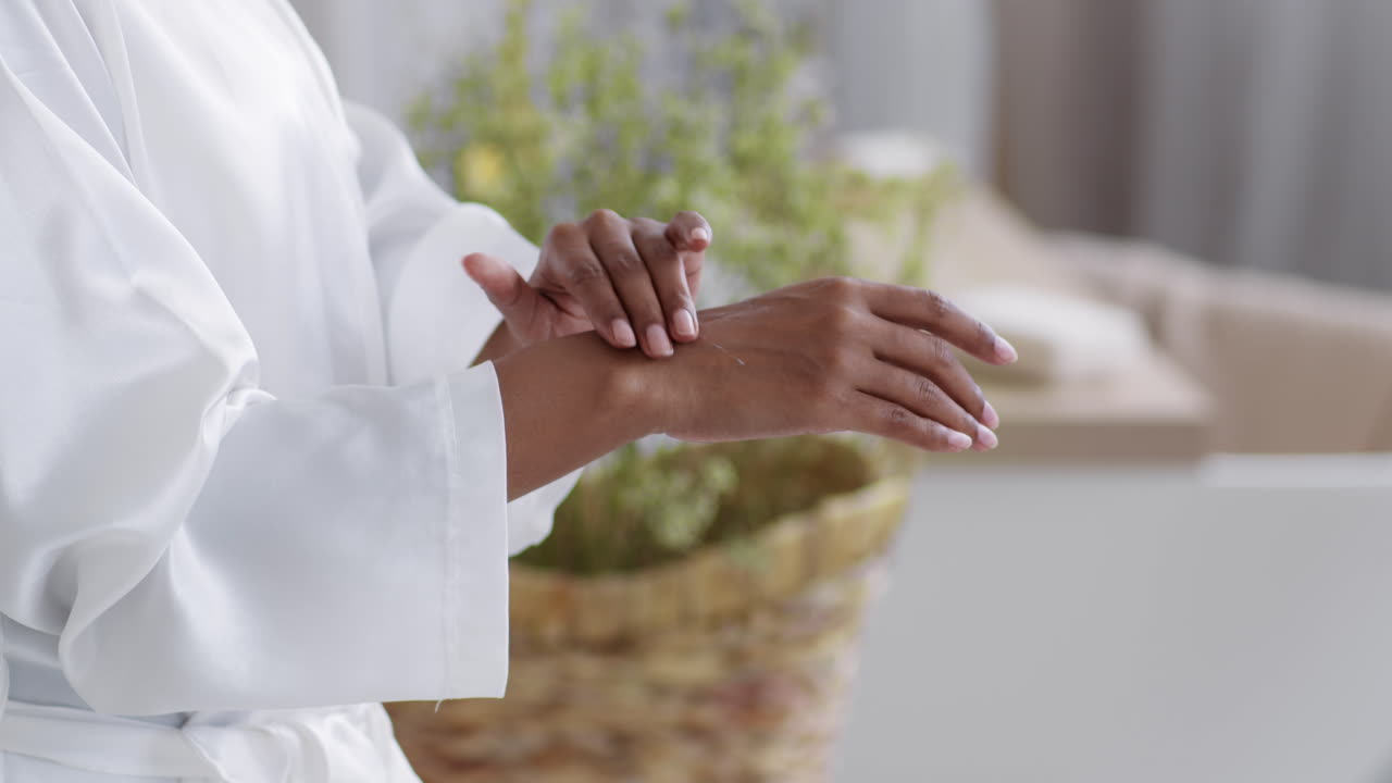 Woman Applying Lotion to Her Hands