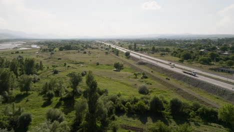 Long-highway-on-gravel-causeway-with-car-traffic-in-rural-Georgia