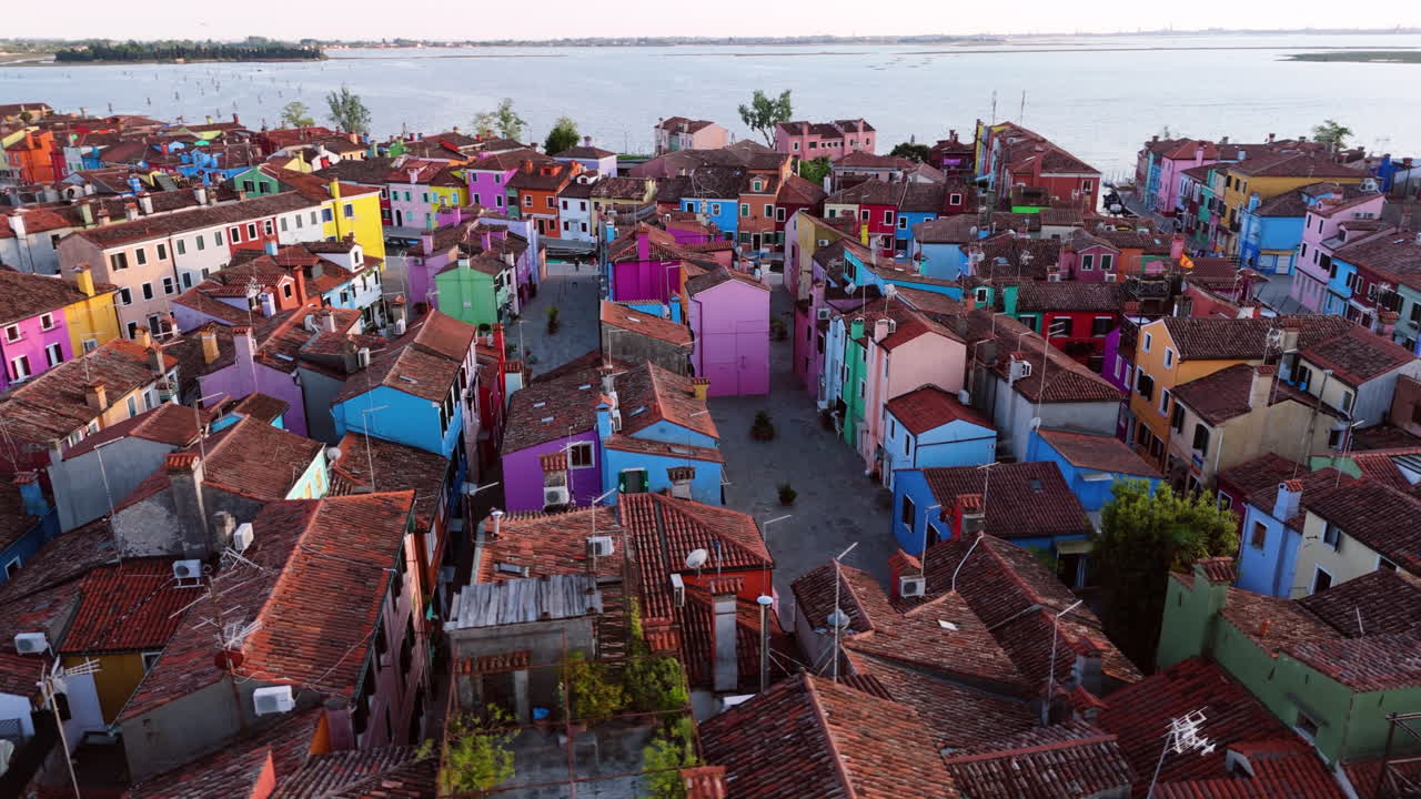 Colorfully Painted Houses In Burano Island In Venetian Lagoon in Venice, Italy. - aerial shot
