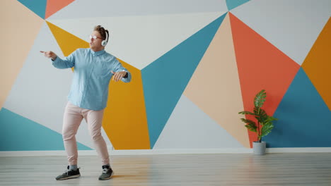 man dancing to music in a colorful room