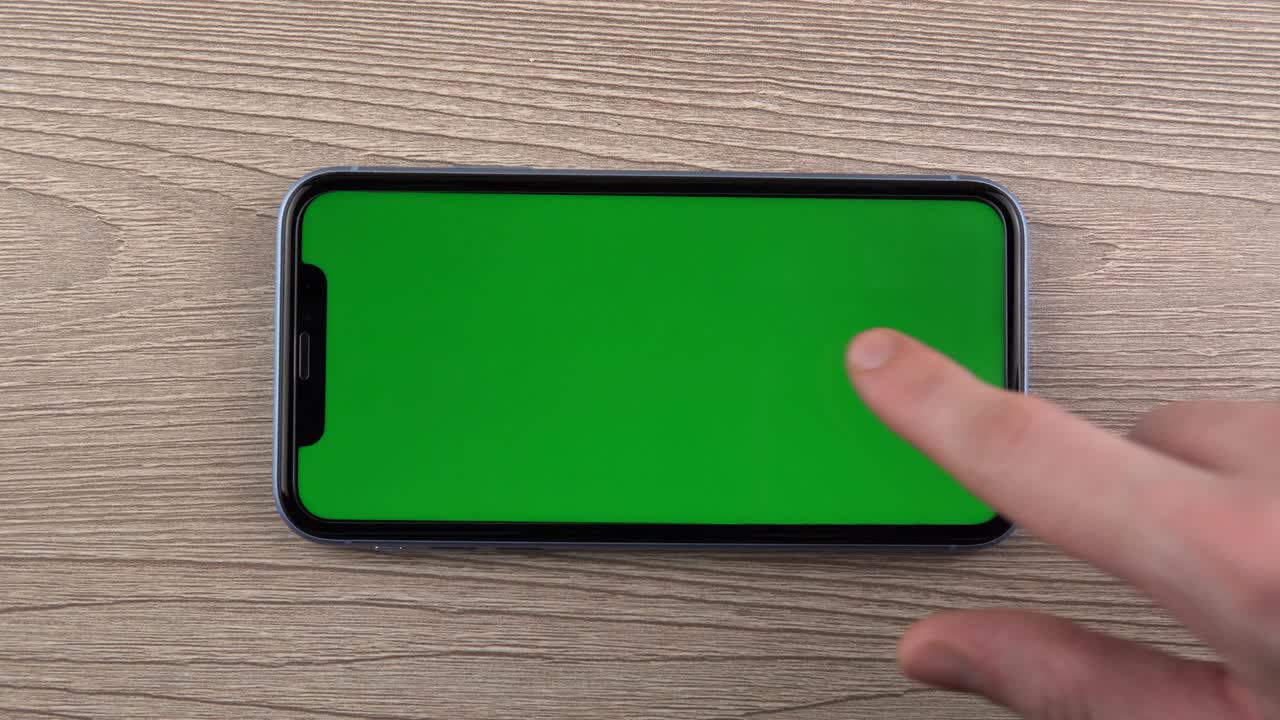 Smartphone with green screen mockup swipe scroll hand close up mobile phone user