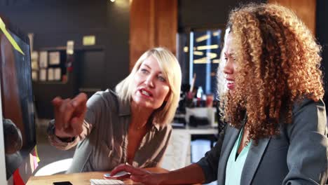 businesswoman interacting with coworkers while working on computer