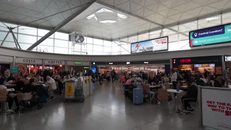 grabbing a bite and coffee at stansted airport arrivals area, london