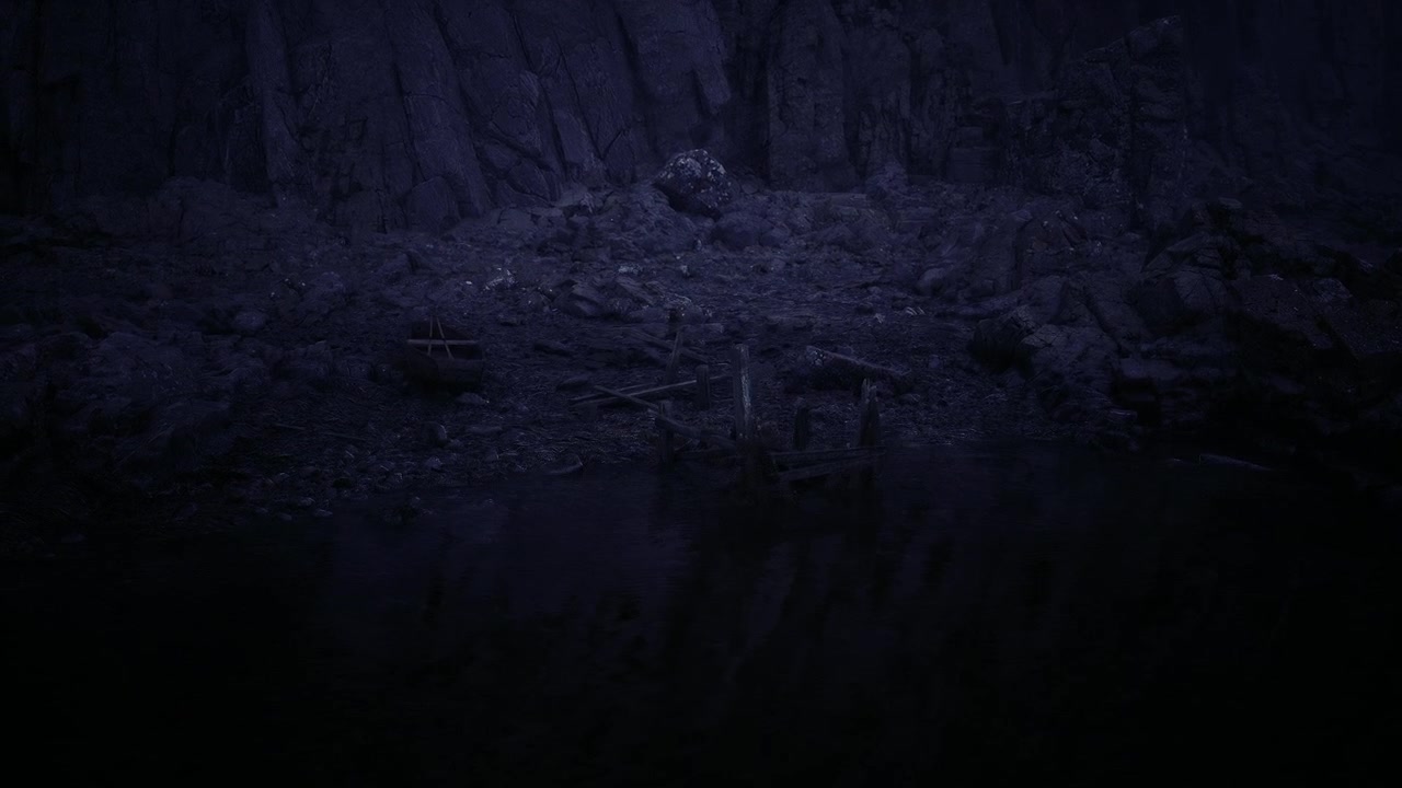 Serene still water at mountain base showcases dark looming silhouette