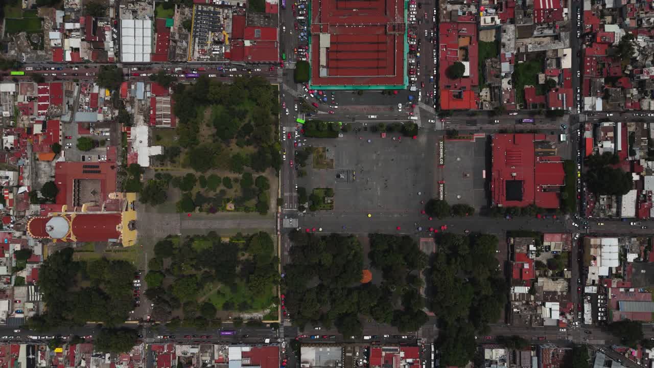 Aerial drone view of Xochimilco's center, with movement of people, cars, and transport