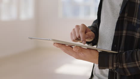 close up hands using digital tablet computer browsing online social media on mobile touchscreen device