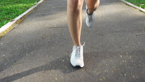 Get-an-up-close-look-at-a-runner's-footwear-with-this-detailed-close-up-footage-of-a-man-jogging-on-a-track