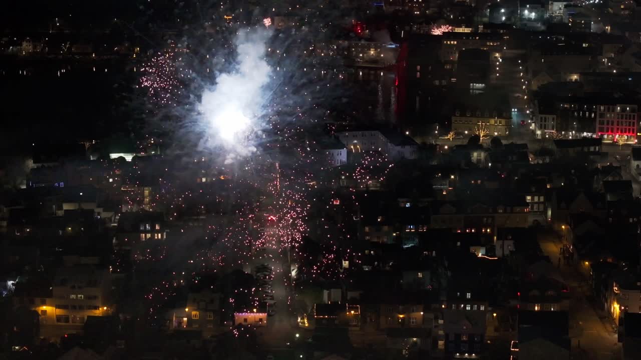 Fireworks flicker over Reykjavik, closeup of vibrant firework display - aerial