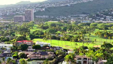 lush green golf course and residential neighborhood in honolulu, hawaii, aerial view