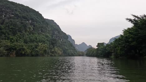 calm river surrounded by lush green mountains