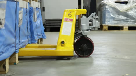 closeup shot of a pallet jack in a industrial warehouse