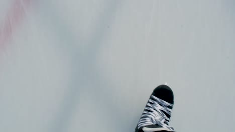 Slow-Motion-point-of-view-of-hockey-skates-crossing-on-ice